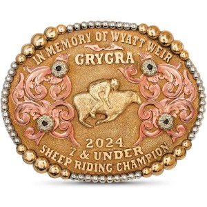 A custom rodeo belt buckle trophy featuring bronze lettering for GRYGRA 2024 Sheep Riding Champion featuring  a mutton busting figure 